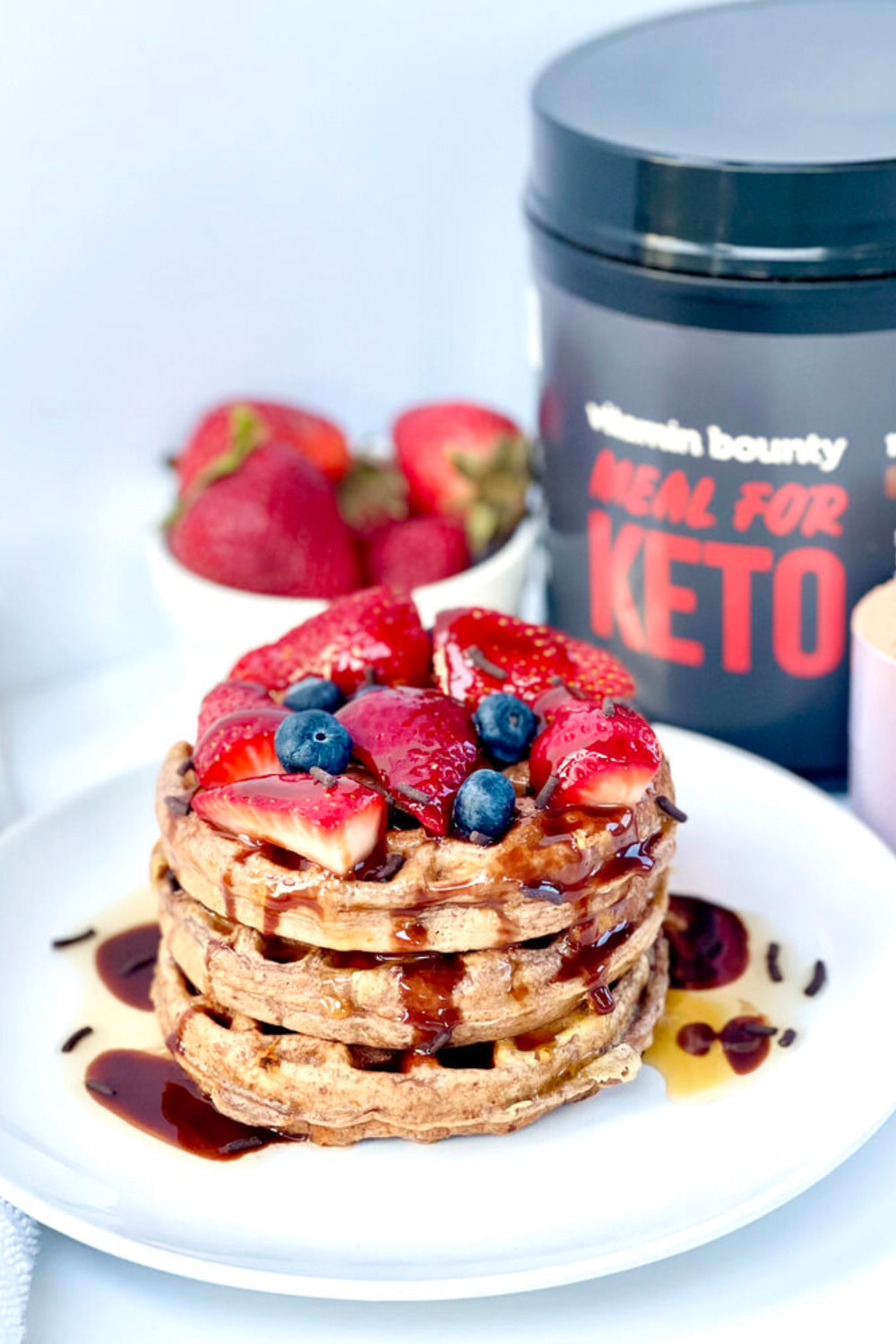 Waffles topped with strawberries and blueberries made with Vitamin Bounty's Meal for Keto