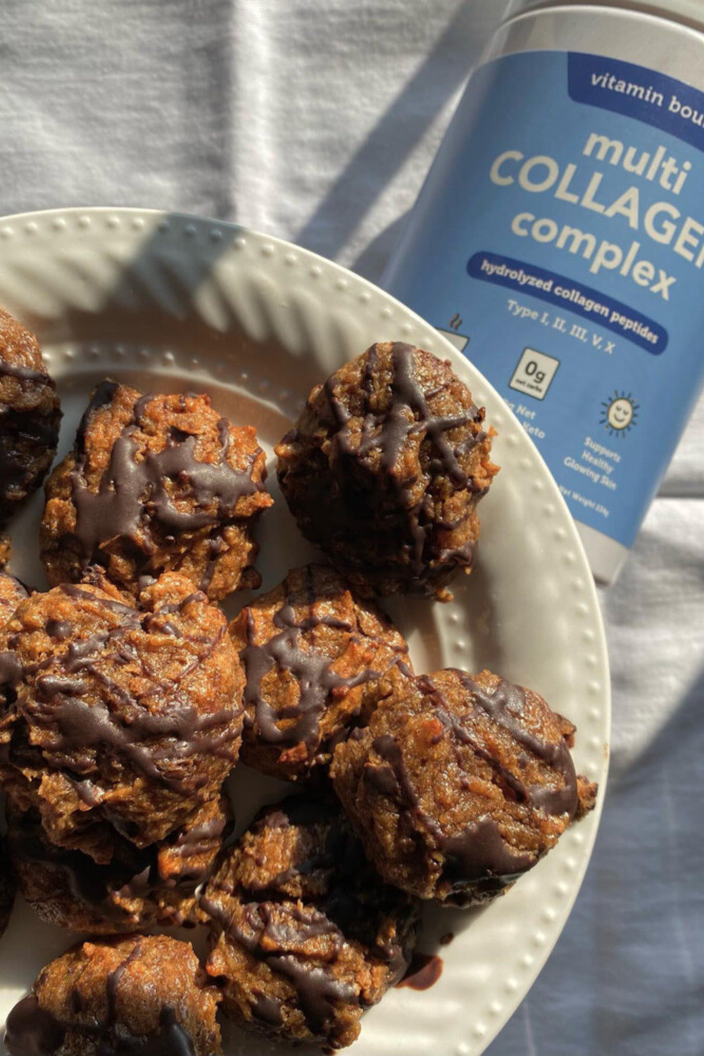 Almond Butter Cookies, on a white plate, pictured with Vitamin Bounty Multi Collagen Complex