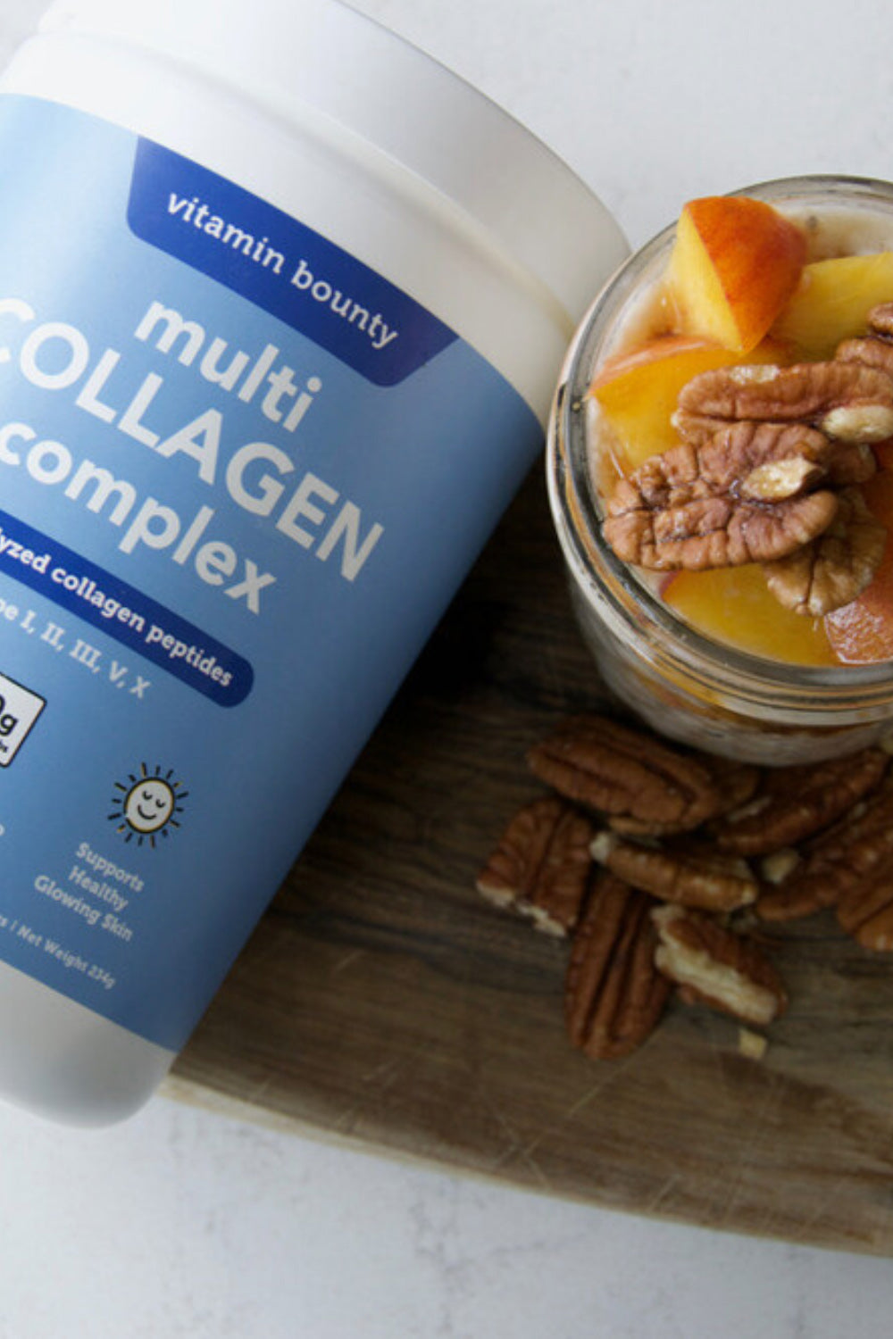 Peaches Overnight Oats made with Multi Collagen Complex, pictured in a mason jar, topped with peaches and nuts