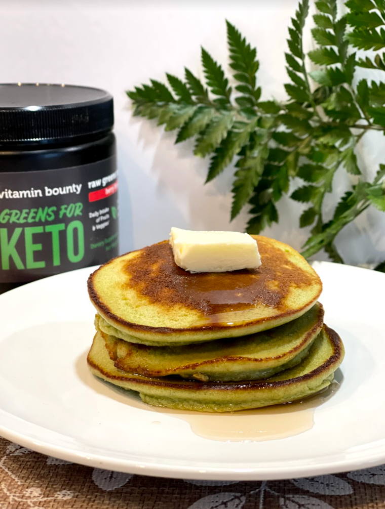 Green pancakes with butter on a white plate, made with Green's for Keto by Vitamin Bounty