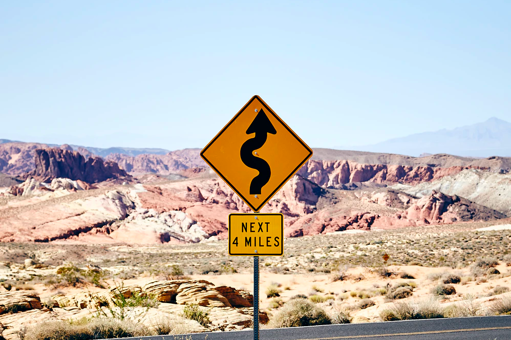 Road Road Sign with Panoramic View of Desert