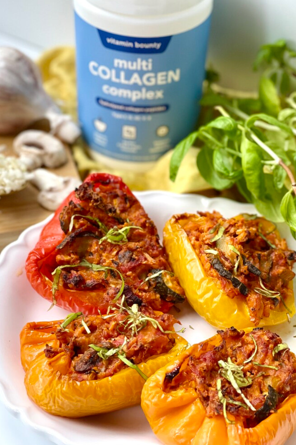 Multi Collagen Complex Stuffed Peppers, pictured with multi colored bell peppers on a white plate