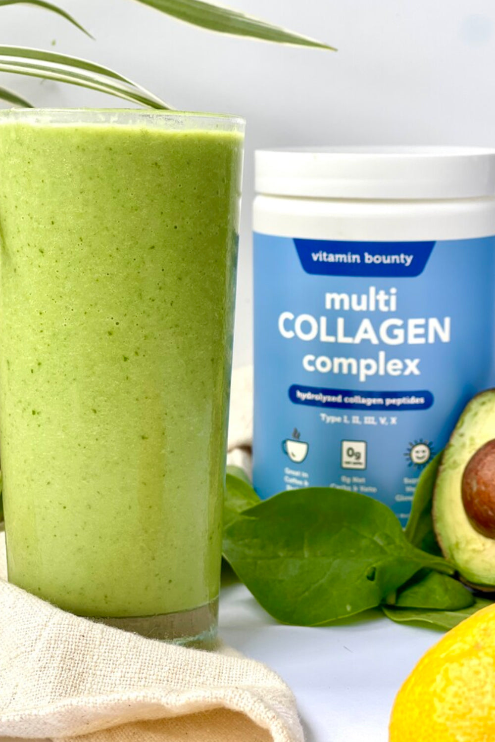 Green Smoothie, made with Vitamin Bounty Multi Collagen Complex. Pictured in a tall glass, beside an avocado and a lemon