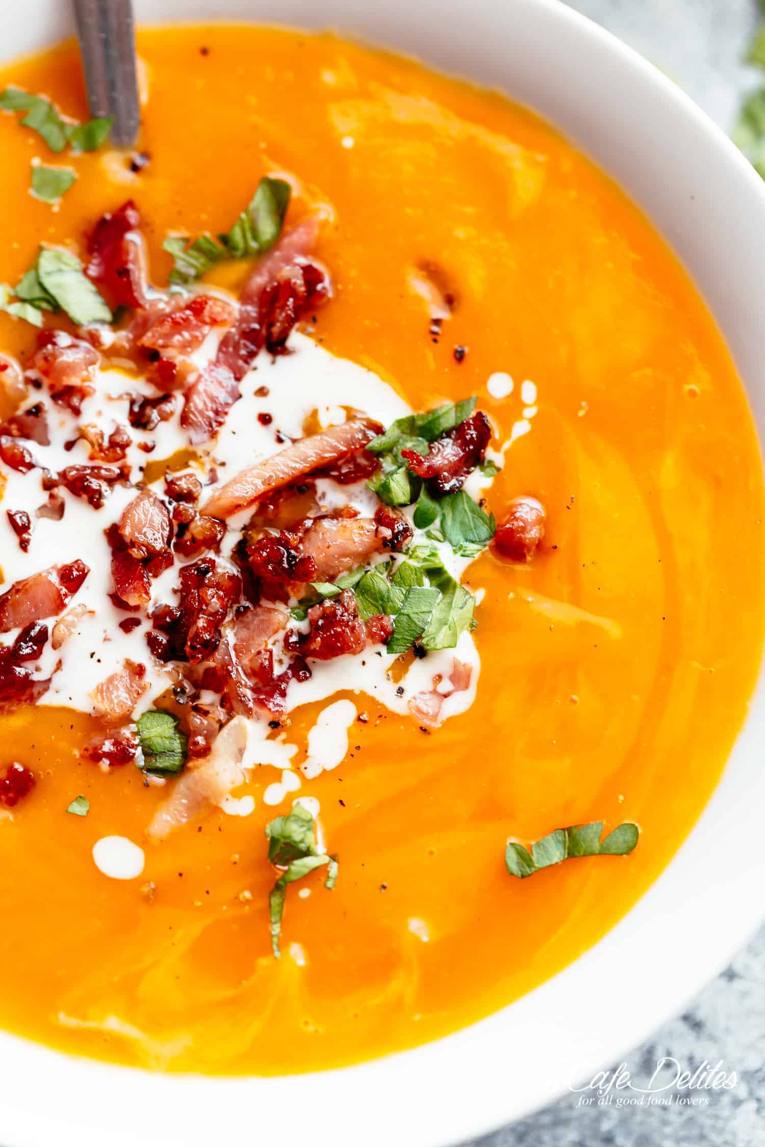 Pumpkin Soup topped with sour cream and bacon 