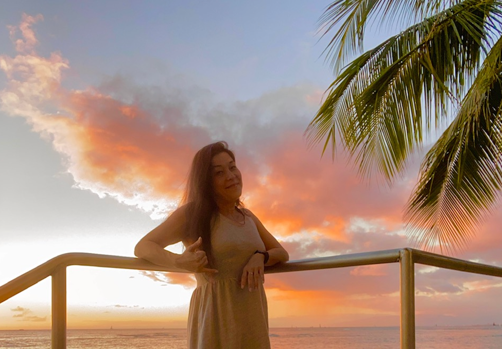 Kerith, who the blog post is written about, is pictured in front of a sunset in Hawaii