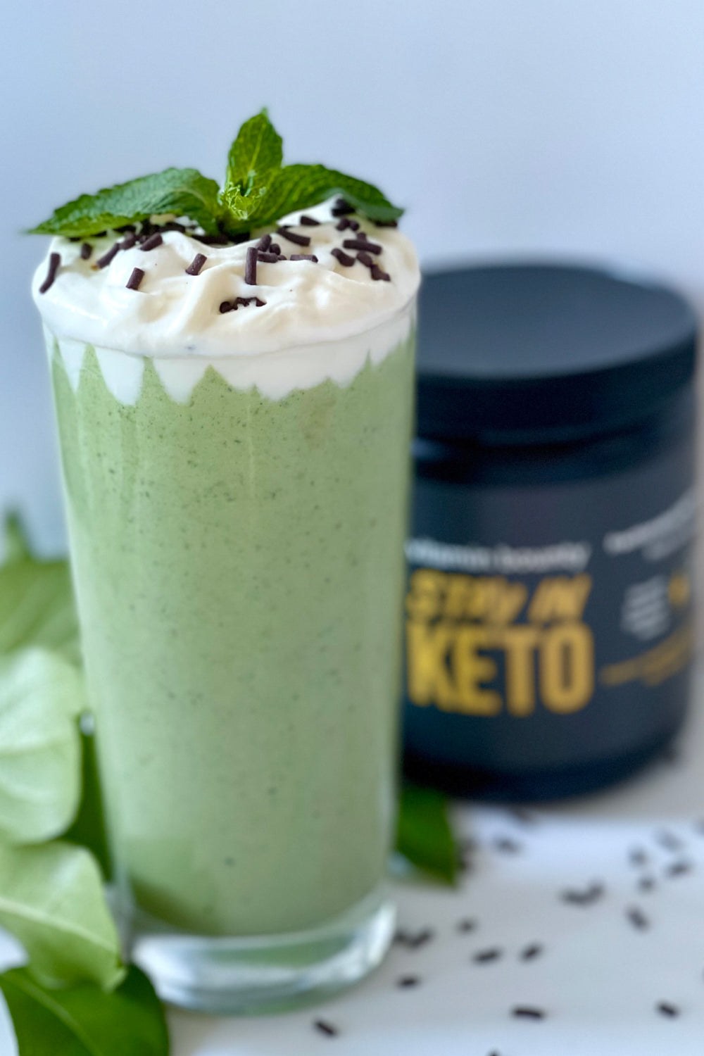 Green milkshake with whipped cream and chocolate sprinkles. Made with Stay in Keto by Vitamin Bounty