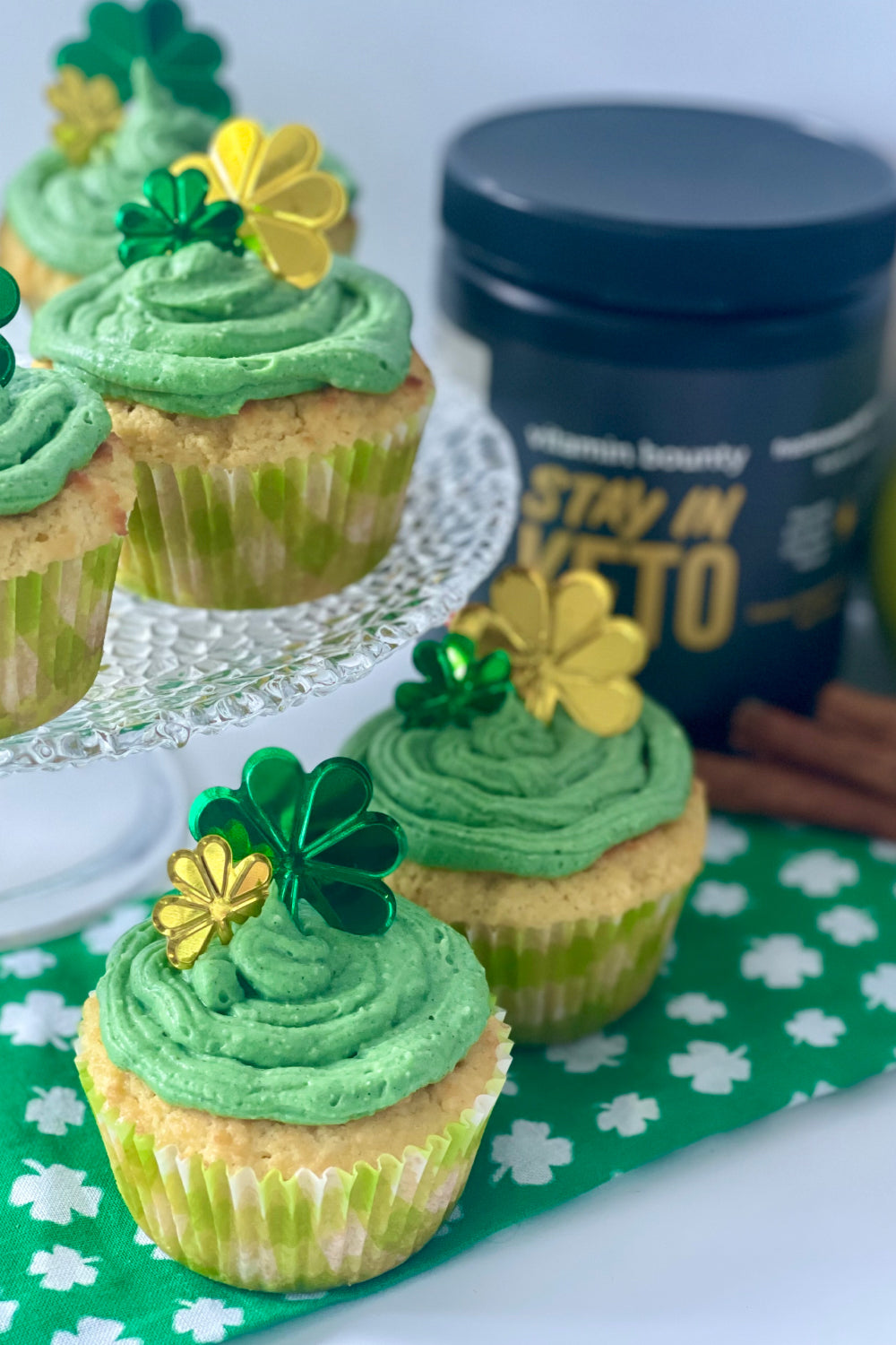 Cupcakes with Green Icing and shamrock charms on top, made with Stay in Keto by Vitamin Bounty