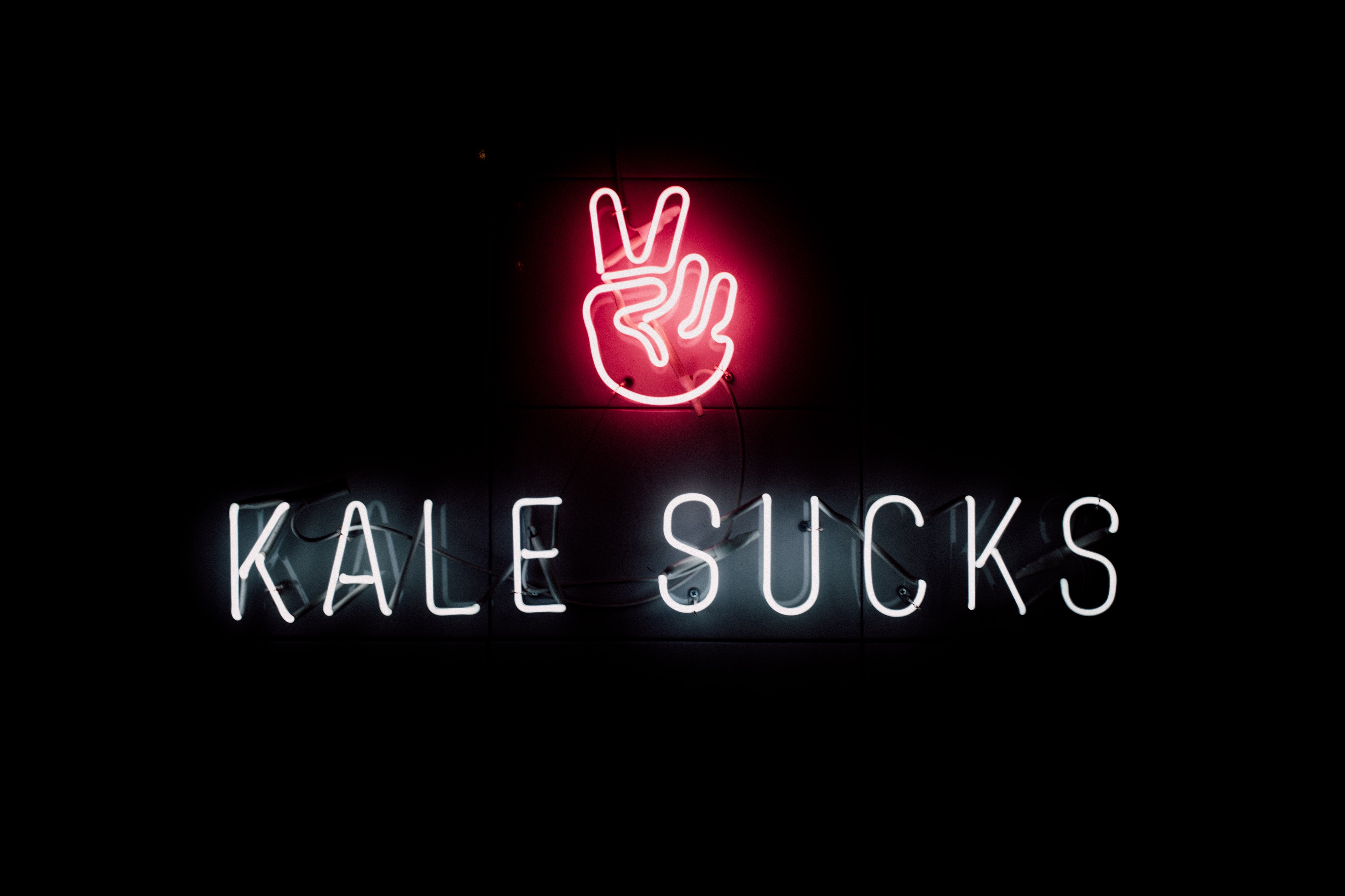 Light sign spelling out "kale sucks"