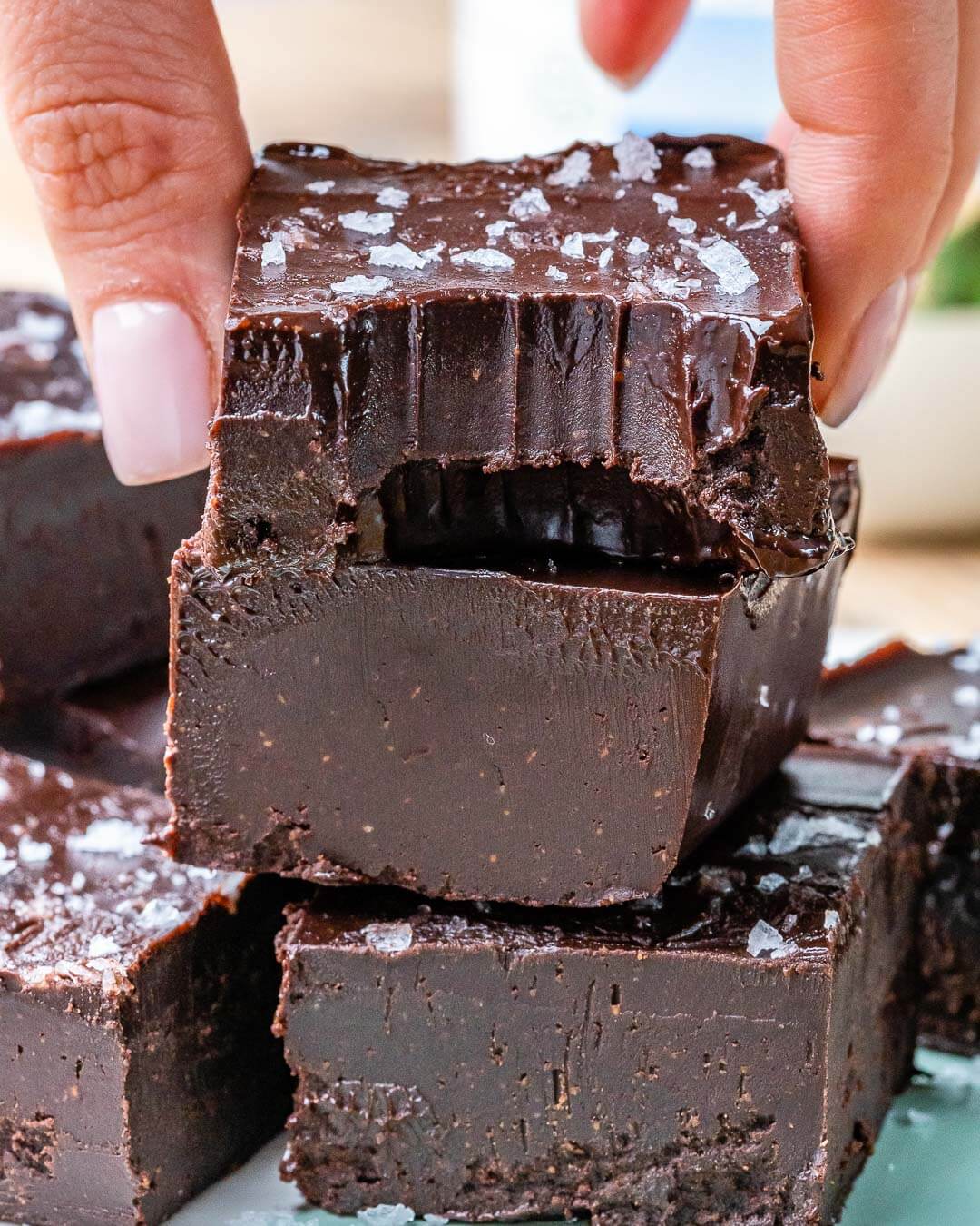 Chocolate Fudge pieces stacked on each other topped with sea salt