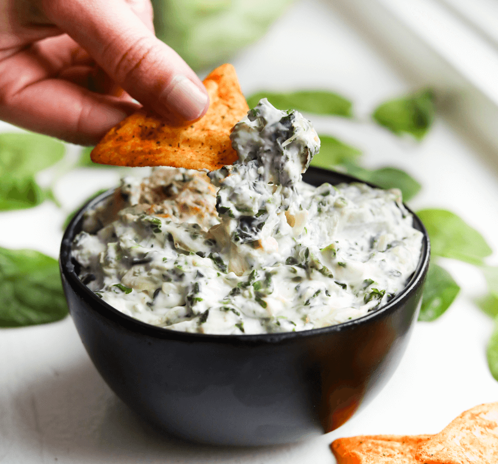 Keto Spinach and Artichoke Dip in bowl with tortila chips